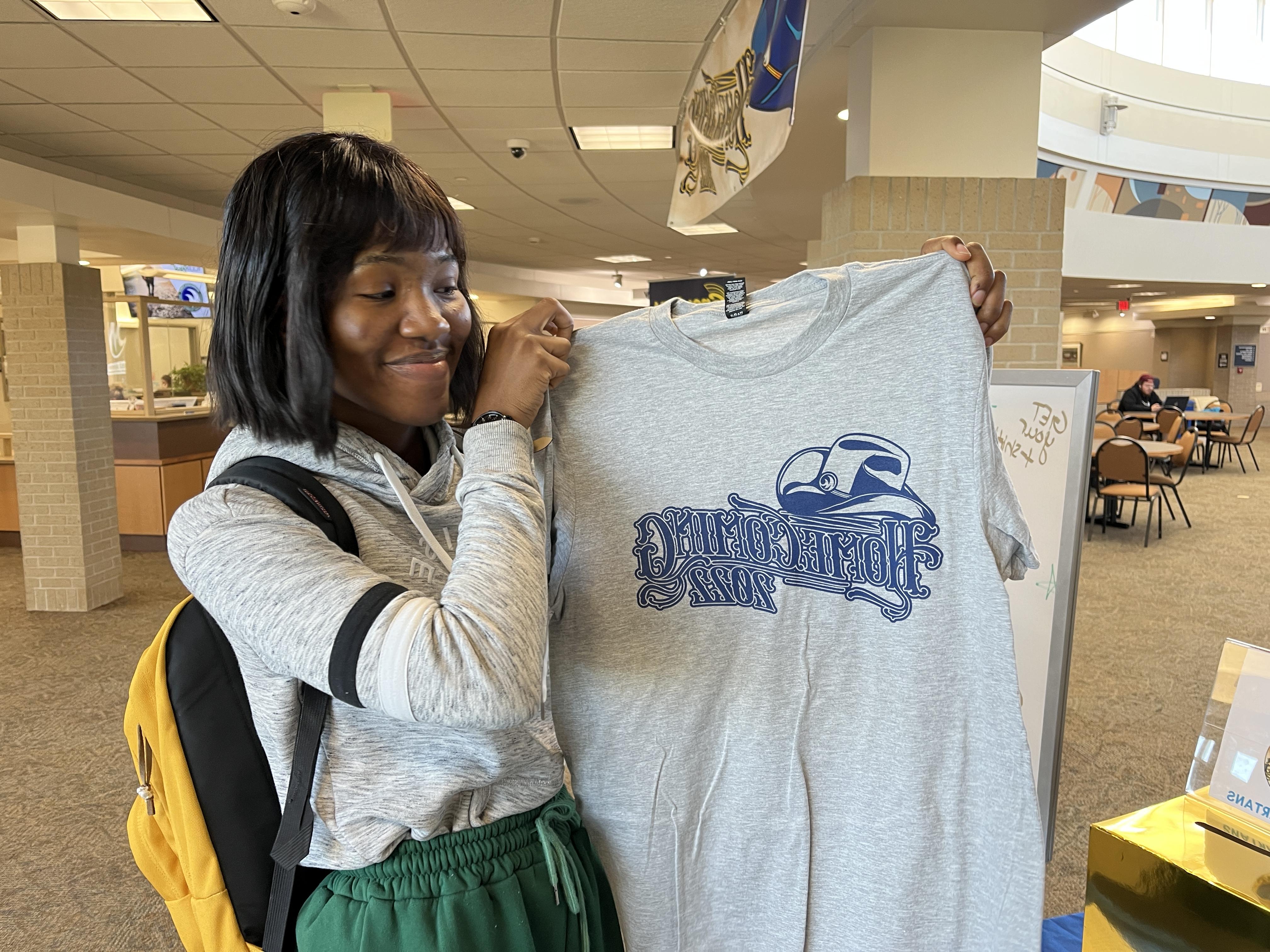 Sabing Menop picking our her Homecoming t-shirt at Spirit Central on the M State Fergus Falls campus