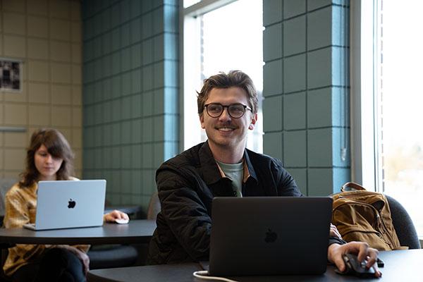 A student works at a laptop