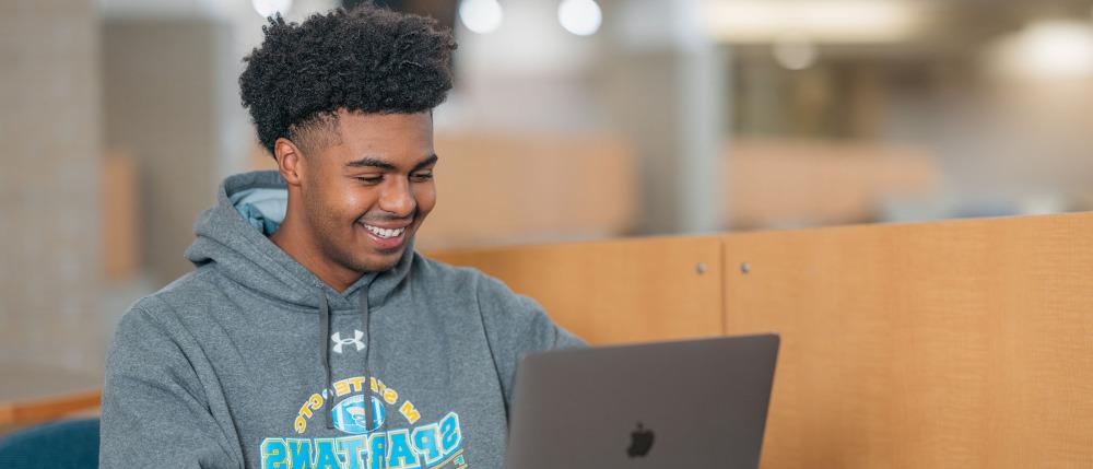 A student works at a laptop